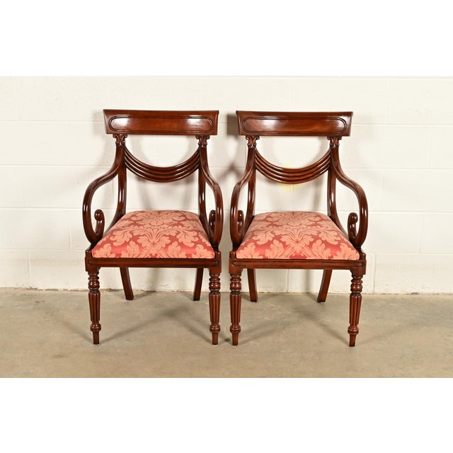 A gorgeous pair of Italian Provincial or English Regency style armchairs or dining captain chairs In the manner of Baker...