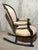 Victorian mahogany and upholstered balloon back rocking chair. Elegant floral upholstery with gimp style trim. Overall in...