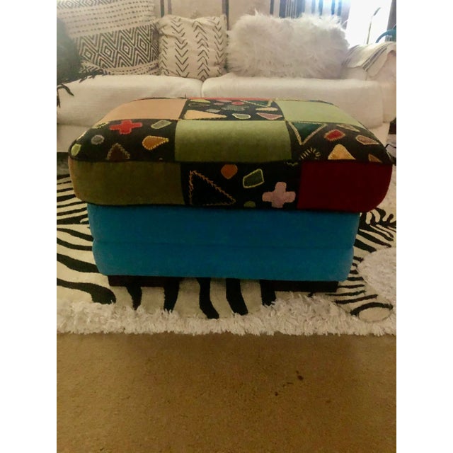Vibrant colored ottoman reupholstered in a multicolored vintage fabric on top and teal/turquoise bottom. The top is from a...