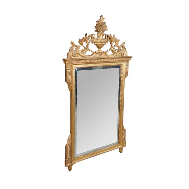 French Louis XVI style gilt wall mirror by the Iconic Mirror Fair of New York, founded in 1911 and currently operated by...