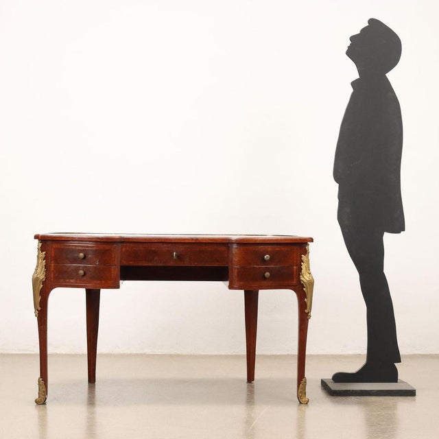 Baroque style desk supported by wavy legs, has two pairs of side drawers on the front and a large central drawer. Veneered...