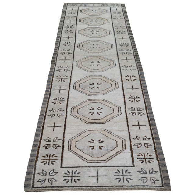 Hand-knotted with care using traditional rug making techniques, this wool rug blends timeless craftsmanship with a modern...