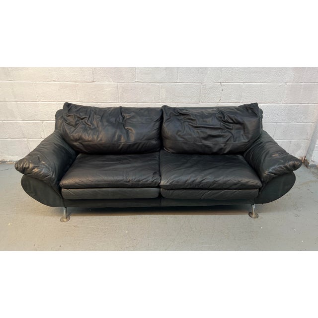 Comfortable and stylish black leather 3-seater sofa with a modern contemporary design. Features oversized cushioned...