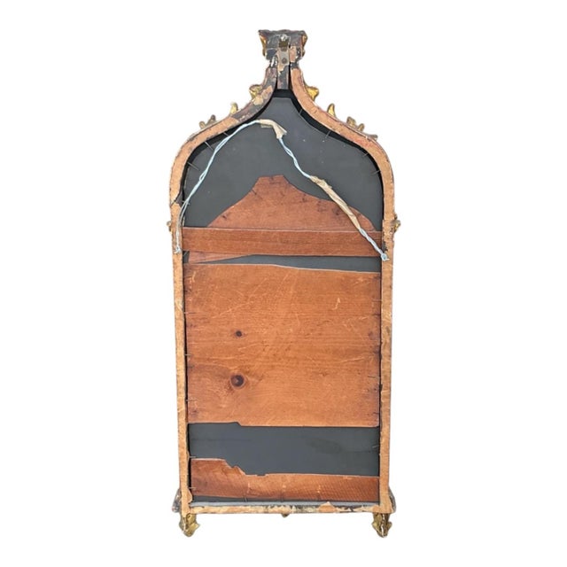 This is a late 19th century petite Italian carved giltwood rococo revival mirror. It is in very good condition with age...