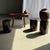 Side table in black petrified wood with beige striations and a fine grain pattern, H35 D24. Petrified wood is a fossilized...
