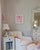 A Women's Exchange Girls Cherry Bubble Framed in a White wood frame shadow box with Ralph Lauren white matelesse fabric...