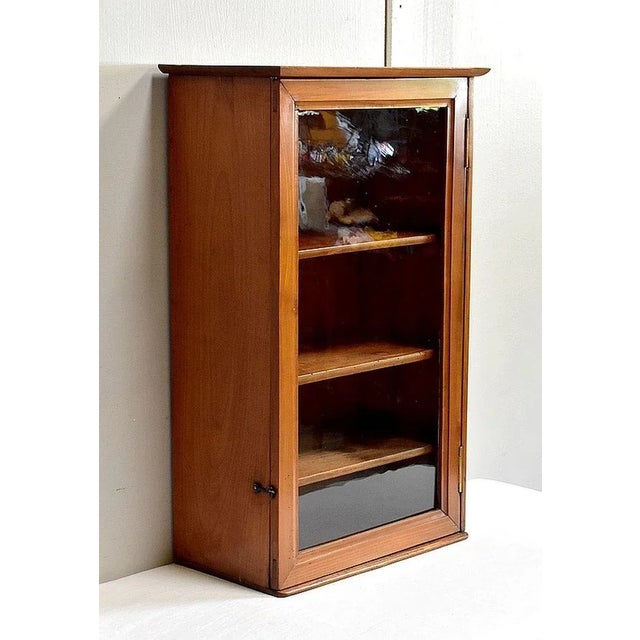 Small Commercial Birch furniture, opening with a Glass Door with frame molding discreetly. The latter is mounted on two...