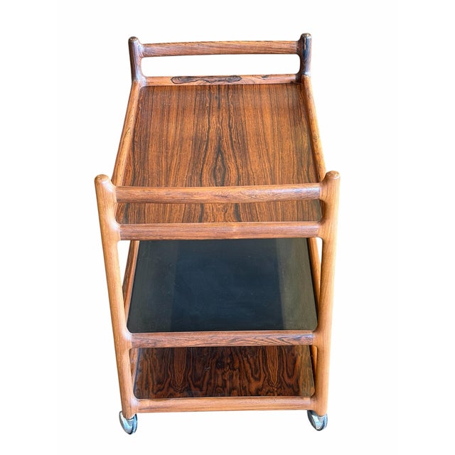 Elevate your entertaining space with this highly sought-after, masterfully crafted Mid-Century Modern Danish bar cart....