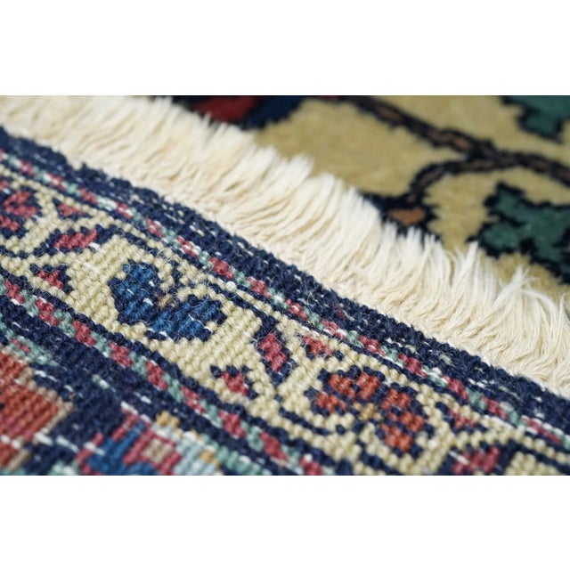 With dark blue and teal half-vases at the corners. The eight pendant medallion in dark blue shows two additional shield...