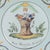 A late 18th century French faience plate entitled Aux Mans des Mirabeau 1790. Hand-painted decoration in green, orange and...