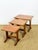 Elegant trio of vintage nesting tables with a design typical of the 1960s. made of teak veneer, they feature a beautiful...