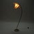 This elegant Mid-Century Modern floor lamp features a gracefully curved brass stem, creating a light, sculptural...