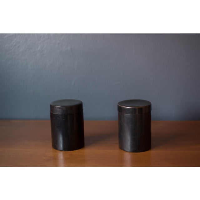 Mid century modern organizing cylinder storage bin with lid, circa 1970's. This unique caddy is wrapped in black leather...