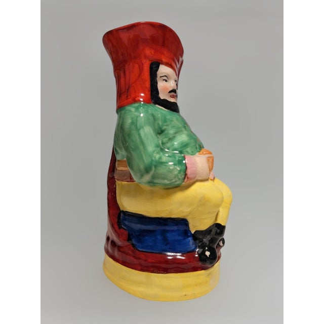 A striking full-figure vintage Toby jug - c. 1885 - featuring a seated bearded man holding his ale tankard. Painted in a...