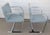 2 flat arm Brno chairs designed by Ludwig Mies van der Rohe made by Gordon International. Both have light blue fabric. One...