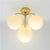 Ceiling lamp made of brass with four white glass balls designed by e. R. Nele for the company temde switzerland. This is a...
