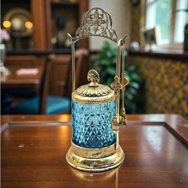 An elegant late 19th century Victoria pickle castor featuring richly faceted cobalt-blue pressed glass suspended within an...