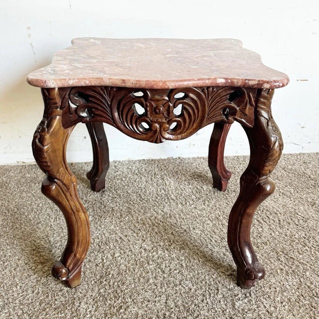 Add a touch of elegance to your home with this Chinese hand-carved rosewood side table. The intricate carvings on the...