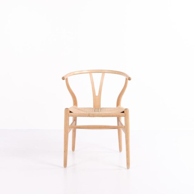 Set of CH24 Wishbone Chairs designed by Hans J. Wegner and produced by Carl Hansen & Søn in the 1960s. Made in oak with...