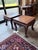 A richly detailed pair of vintage Asian hardwood low tables with strong Chinoiserie character. Each features a framed...