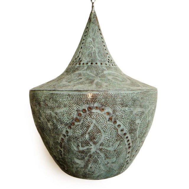 Beautiful verdigris handmade copper lantern with perforated decorative design that emanates intricate light patterns. Open...