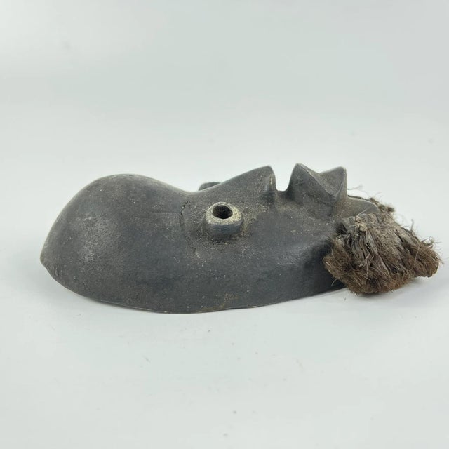 Small passport mask used to be carried around when traveling. This African mask comes from Liberia and CÃ´te d'Ivoire by...