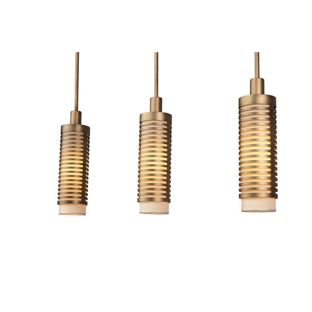 Pollux Tripla is a linear three-element metal pendant light made in Italy, designed as a balanced and rhythmic...