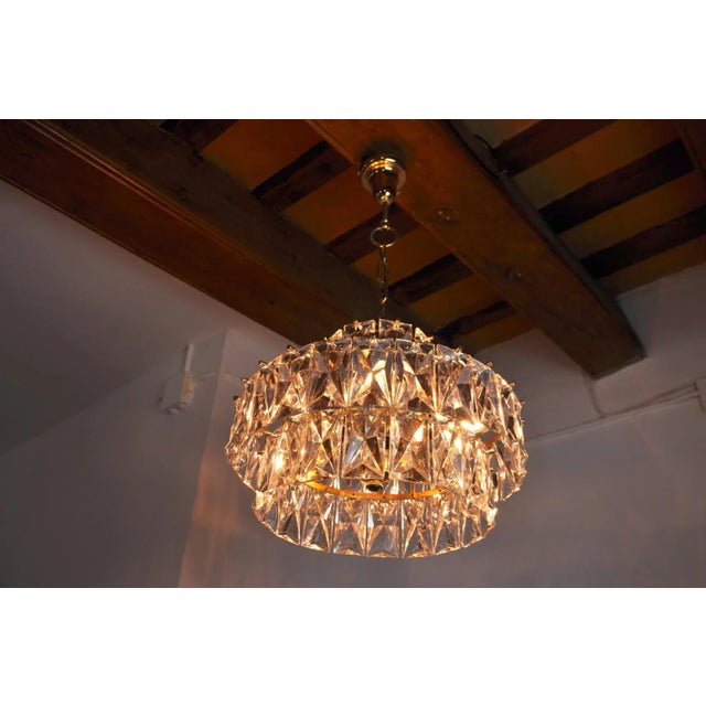 Rare and large kinkeldey chandelier designed and produced in Germany in the 70s. Structure in gilded metal made up of cut...