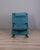 Rocking chair with metal and foam frame, light blue fabric upholstery, black rubber legs and armrests. "T-Line" model,...