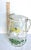 Midcentury Glass Pitcher with Green, Yellow and White Painted Flowers. Unusual shape. Very good vintage condition with a...