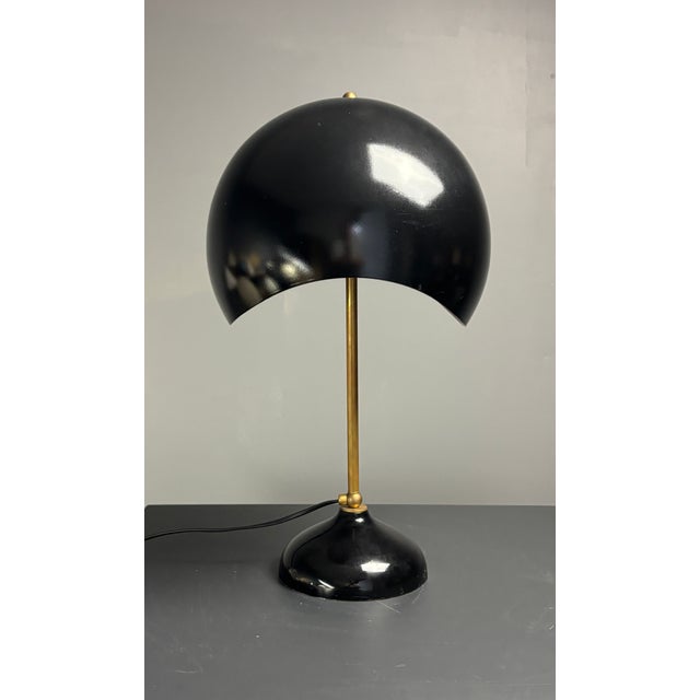 Wonderfully proportioned desk or table lamp in black metal shade on brass base. This midcentury Italian lamp is in great...