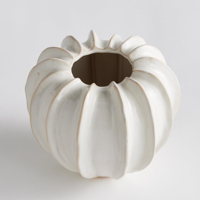 With a sculpted body and thickly applied glaze, this coastalinspired low bowl is a work of art. The handfinished details...
