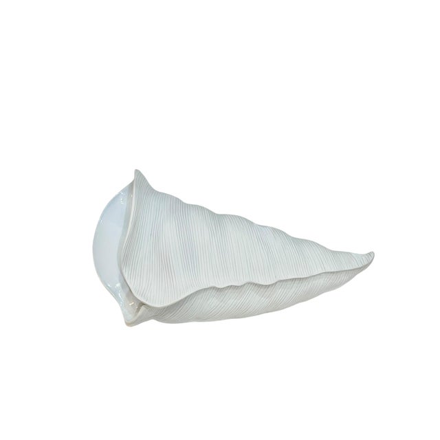 Unusual Crate & Barrel vase in the form of a whelk shell. This vase is designed to lay flat. Unique texturized design....