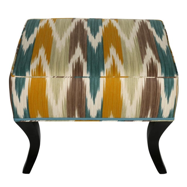 A pair of vibrant multicolor ikat upholstered benches with flared legs. The newly upholstered seats have a flamestitch...