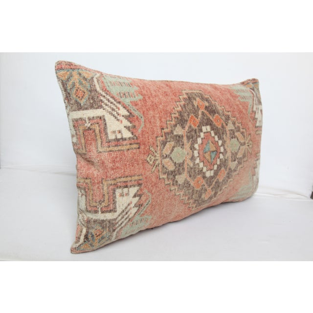 This handcrafted lumbar pillow cover is made from a vintage tribal Turkish Rug, showcasing a beautifully aged patina and...