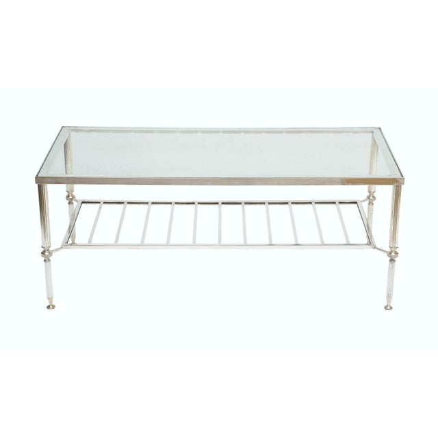 A fine French low or coffee or cocktail table from the Mid-Century Modern period, featuring an inset rectangular glass top...
