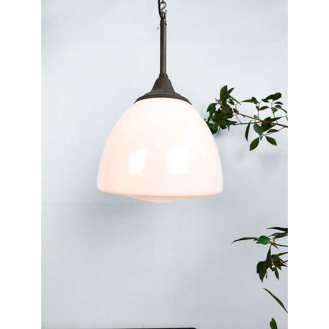 : Beautiful early Dutch opaline pendant lights by Philips. Constructed out of glass with unusual brass fixtures....