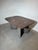A striking sculptural dining table crafted entirely from granite, featuring a unique three-piece construction. The...