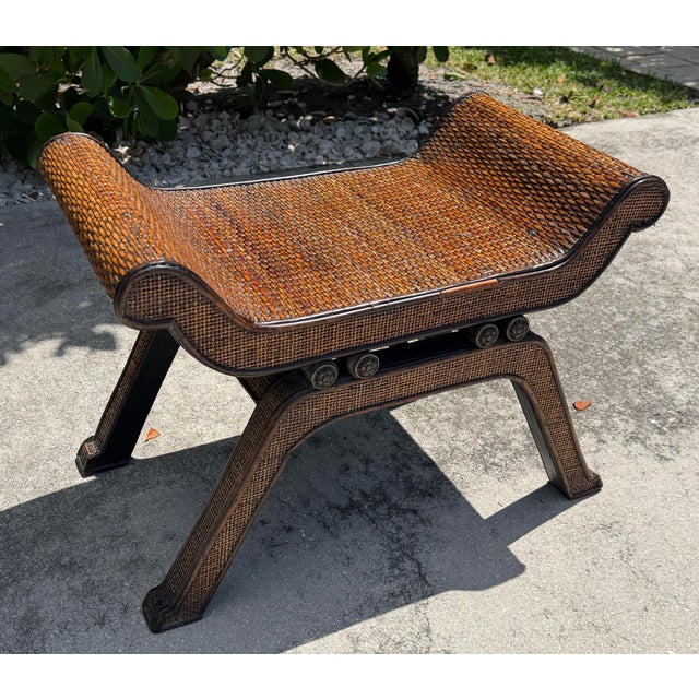 Vintage Egyptian-inspired woven rattan footstool or low occasional table with a distinctive sculptural form. The piece...