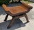 Vintage Egyptian-inspired woven rattan footstool or low occasional table with a distinctive sculptural form. The piece...
