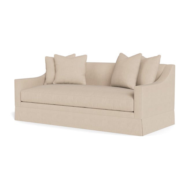 A handsome, modern skirted sofa with sloped arm, available in two sizes. Sleek tailoring complemented by a single seat...