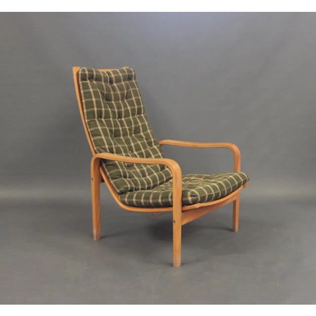 This pair of easy chairs with stool was designed by Alf Svensson and manufactured by Källemo AB. The chairs are in beech...