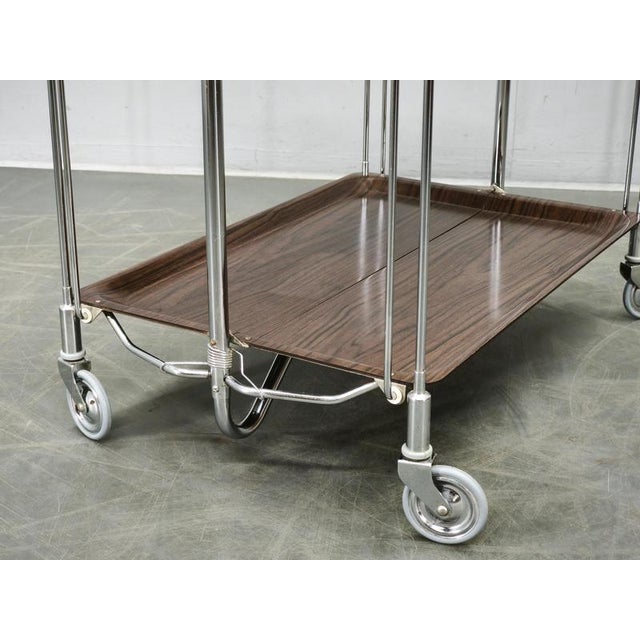 Distinctive folding serving trolley produced in Germany during the 1960s, combining a lightweight chrome-plated tubular...
