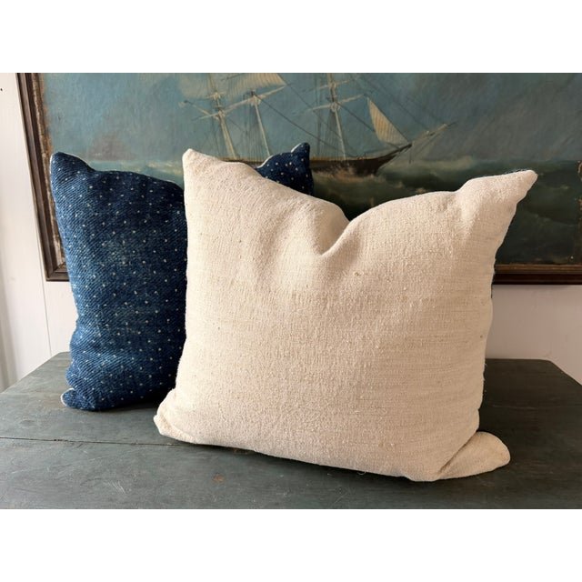 Pillows made from antique grain sacking material, heavy slubby linen, dyed indigo blue with polka dots. Alternate side in...