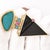 A retro-inspired 14K gold pendant featuring Paraiba and pink tourmalines, triangle cut amethyst, rough turquoise and a...