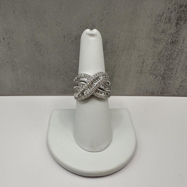 This eye catching diamond crossover style fashion ring is crafted in 10K white gold and features 1.00 carat total weight...