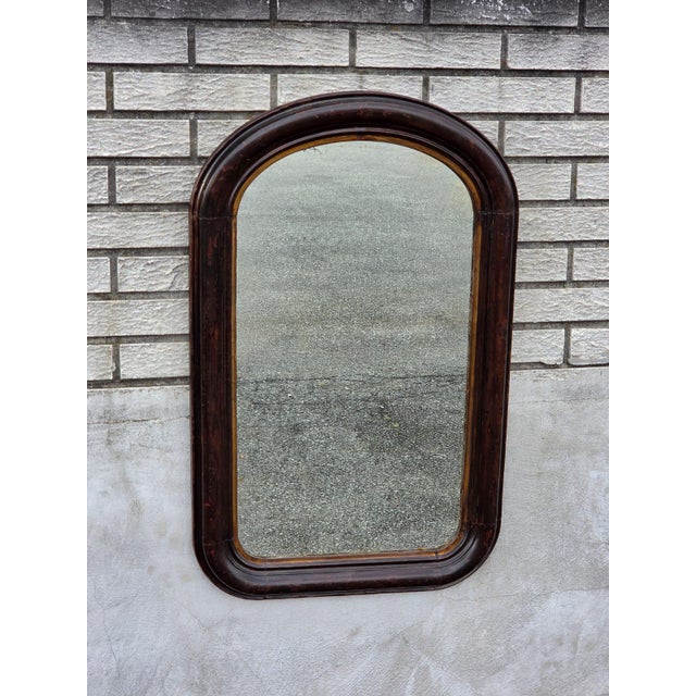 This 19th century Victorian walnut mirror is a genuine antique piece from the Victorian era, dating back to the year 1900....