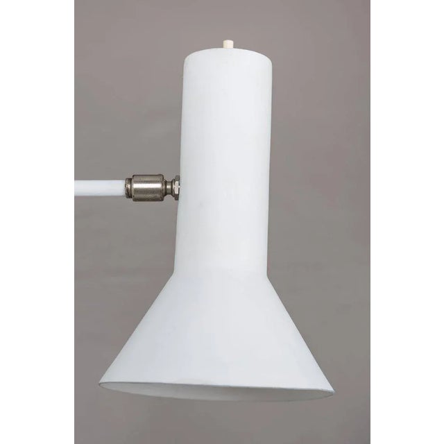 J.J.M. Hoogervorst swivel-arm wall lights for Anvia, 1960s. Executed in white painted metal, the arm swings from side to...