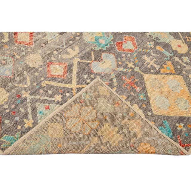 Beautiful Moroccan style handmade wool rug with a gray field. This Modern rug has multicolor accents featuring a gorgeous...