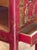 A slender side table of bedside form, decorated overall on a red ground with raised gilt chinoiserie. The galleried top...
